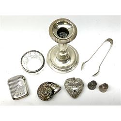 Group of silver, comprising late Victorian vesta case with part ribbed decoration, hallmarked Birmingham 1895, maker's mark worn and indistinct, pair of sugar tongs, hallmarked Birmingham 1936, maker's mark also worn and indistinct, an Edwardian silver mounted candlestick with filled base, hallmarked A E Goodby & Son, Birmingham 1906, small cut glass bowl/open salt with silver mounted rim, hallmarked London, and two hallmarked silver thimbles, plus a base metal snuff modelled as a nautilus shell, and a base metal vesta.