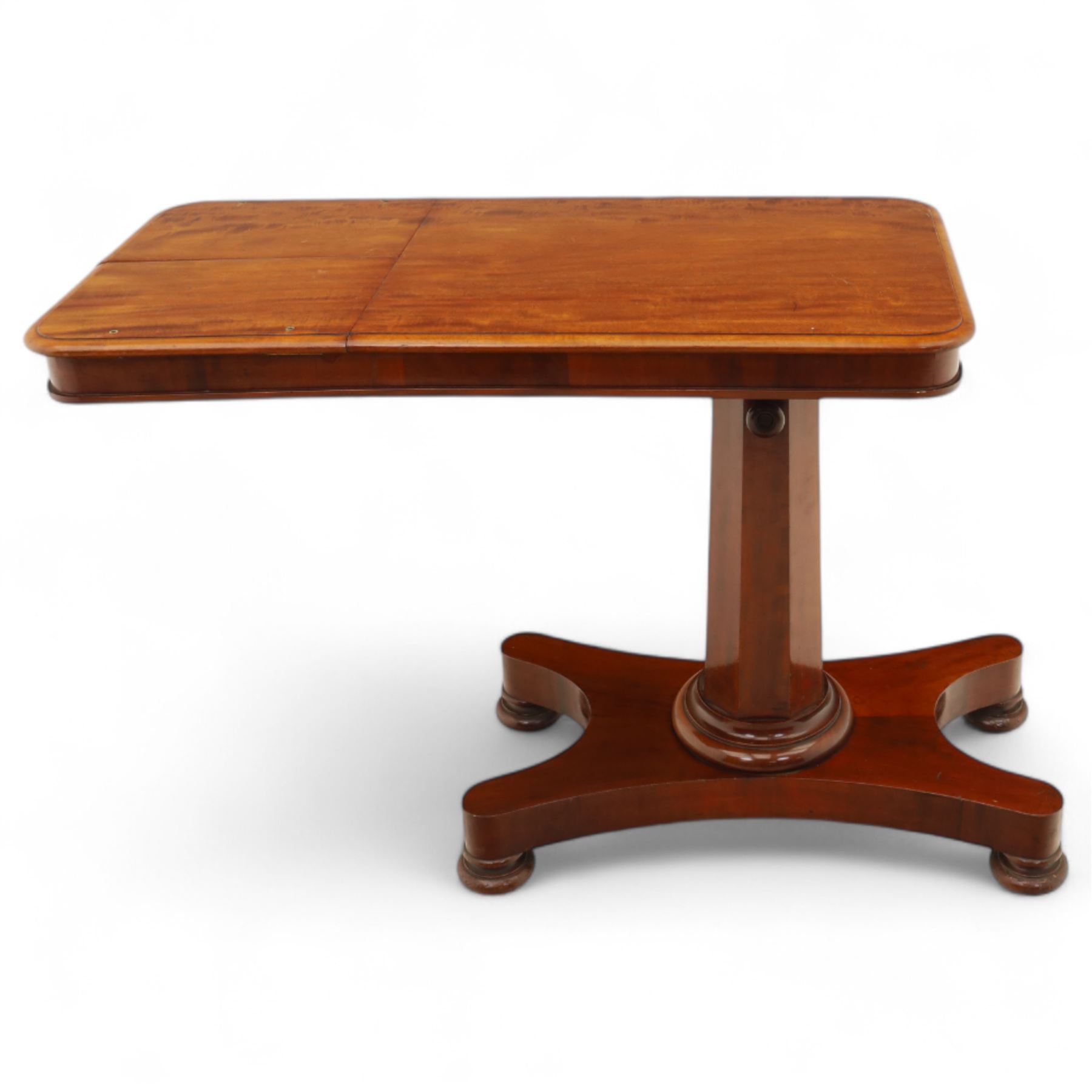 William IV mahogany reading table, the rectangular top with rounded corners and moulded edge, one end fitted with two hinged adjustable reading slops with two rests, the sliding top with a sprung stay mechanism, supported on a single tapered faceted column  with turned collar on a quatreform base with compressed bun feet