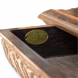 French carved oak cabinet in the Renaissance revival style, cornice carved with scrolling acanthus flanked by lion mask ring terminals, above glazed door with scroll supports over a carved panelled cupboard section with radiating shell motif and geometric quarter panels with foliate ornamentation, raised on a moulded plinth base 