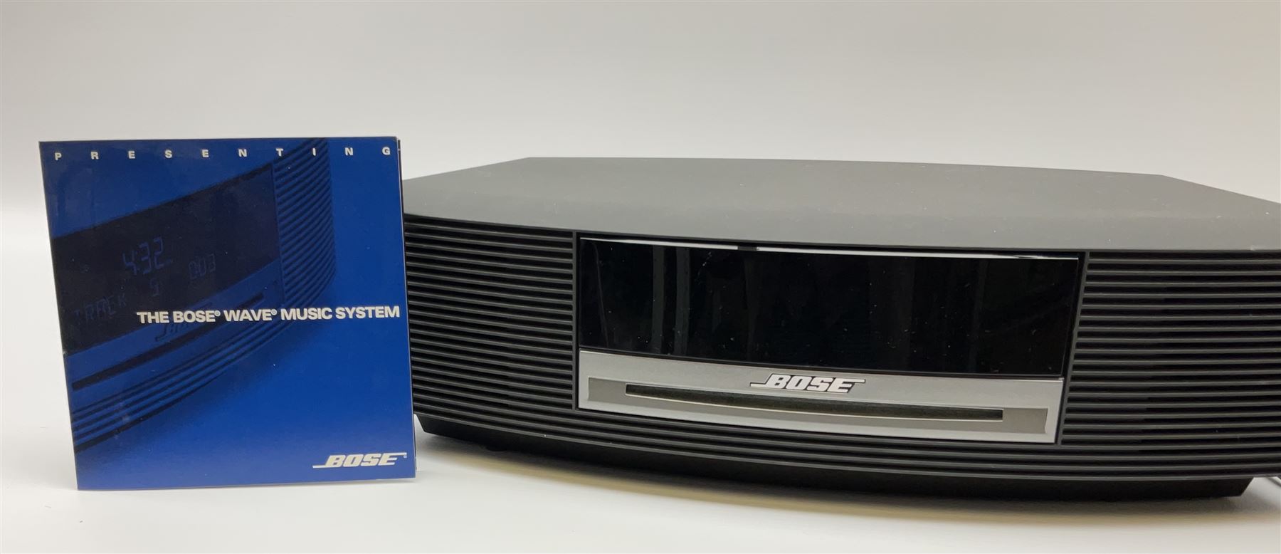 A Bose Wave music system, model AWRCC5, with remote control. 