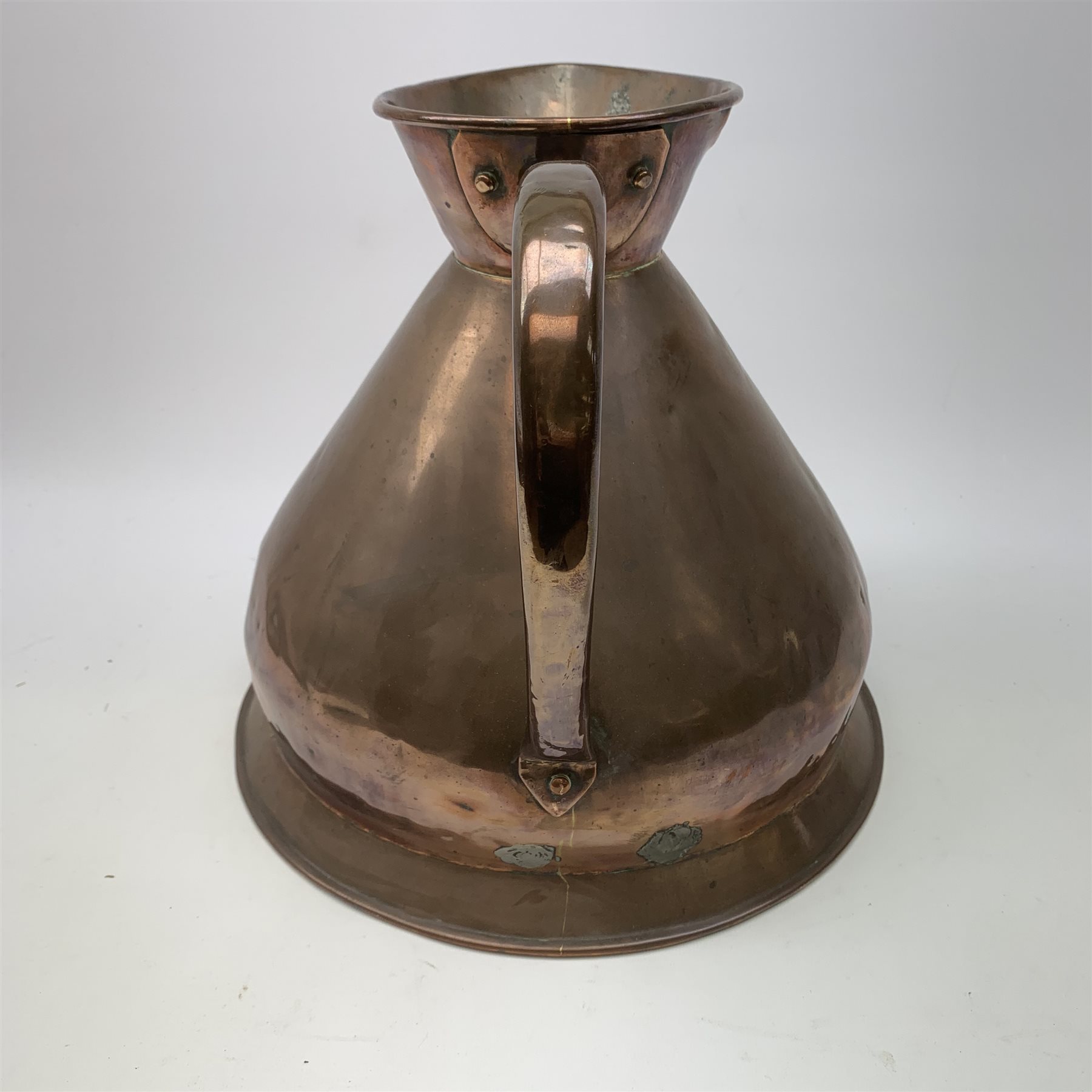A large 19th century Copper measuring jug, marked 2 Gallon, with lead