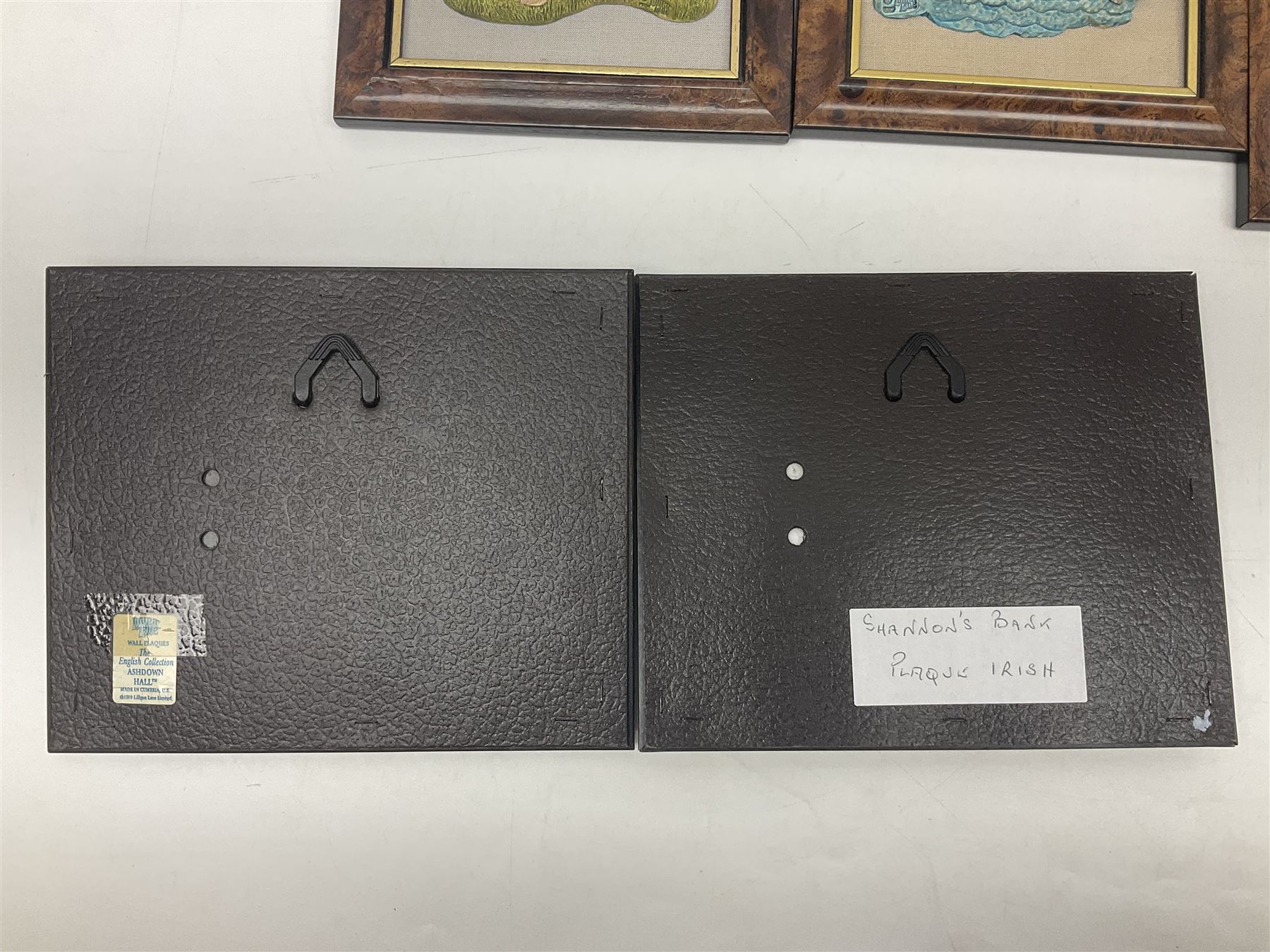 Nine Lilliput Lane framed wall plaques, including Fell View, Battleview, Catslide Cottage, Ashdown Hall and Shannon's Bank, together with three smaller circular framed Lilliput Lane plaques