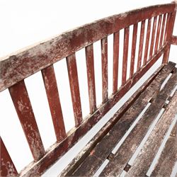 Teak garden bench, with slatted seat and spindle back, shaped armrests, finished in weathered red painted finish.