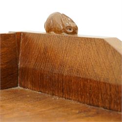 Rabbitman - oak glazed bookcase or display cabinet, lightly adzed rectangular top with raised gallery, twin glazed doors enclosing two shelves, over a pair of panelled cabinet doors with wrought iron fittings, with carved rabbit signature, by Peter Heap of Wetwang