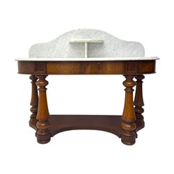 Mid-19th century mahogany washstand, the serpentine white marble top with raised gallery back and central shelf above a frieze drawer, supported by turned columns united by a shaped undertier, raised on bun feet