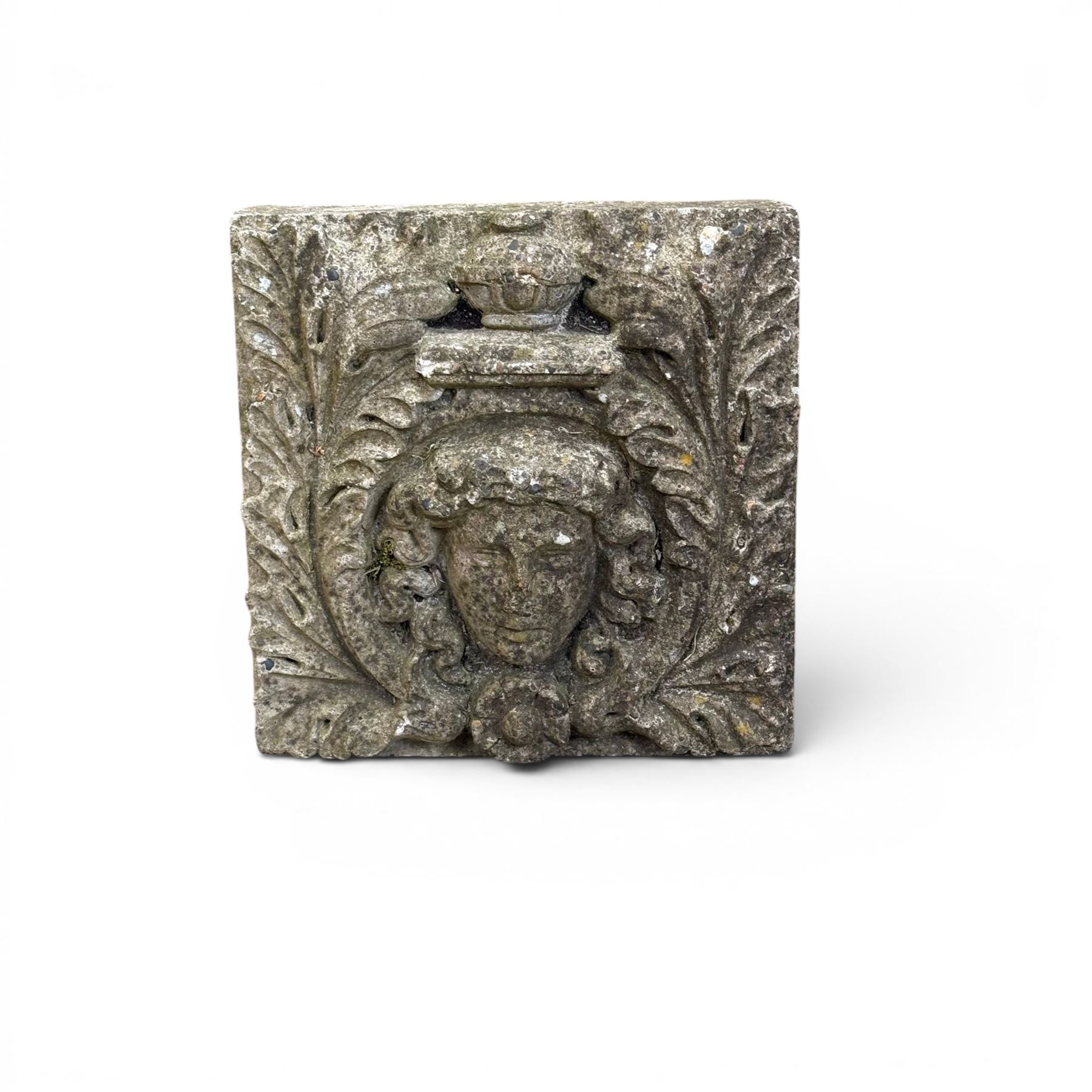 Weathered cast stone decorative wall panel, central female mask with urn motif surrounded by foliage