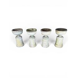 Four 20th century good quality weathered cast stone pedestal urns, circular lobed bowls with rope twist and lattice border, raised on squat base with fluted columns