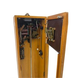 A mid-20th century Gent of Leicester(Blick Electric) Pulsynetic Master Clock in a full length glazed wooden case, with a square white dial with Arabic numerals, minute markers and baton hands, with pendulum and a record card dating from the 1970’s. 
This master clock would have been wired to send time signals to other slave dials in a large building, frequently used in hospitals, schools and factories during the 20th century
With a second electrical movement housed in a glazed square cabinet.


