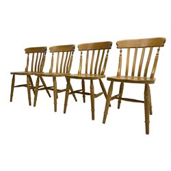Set of four beech farmhouse design dining chairs, shaped bar back over vertical slats, on turned supports united by H stretchers 