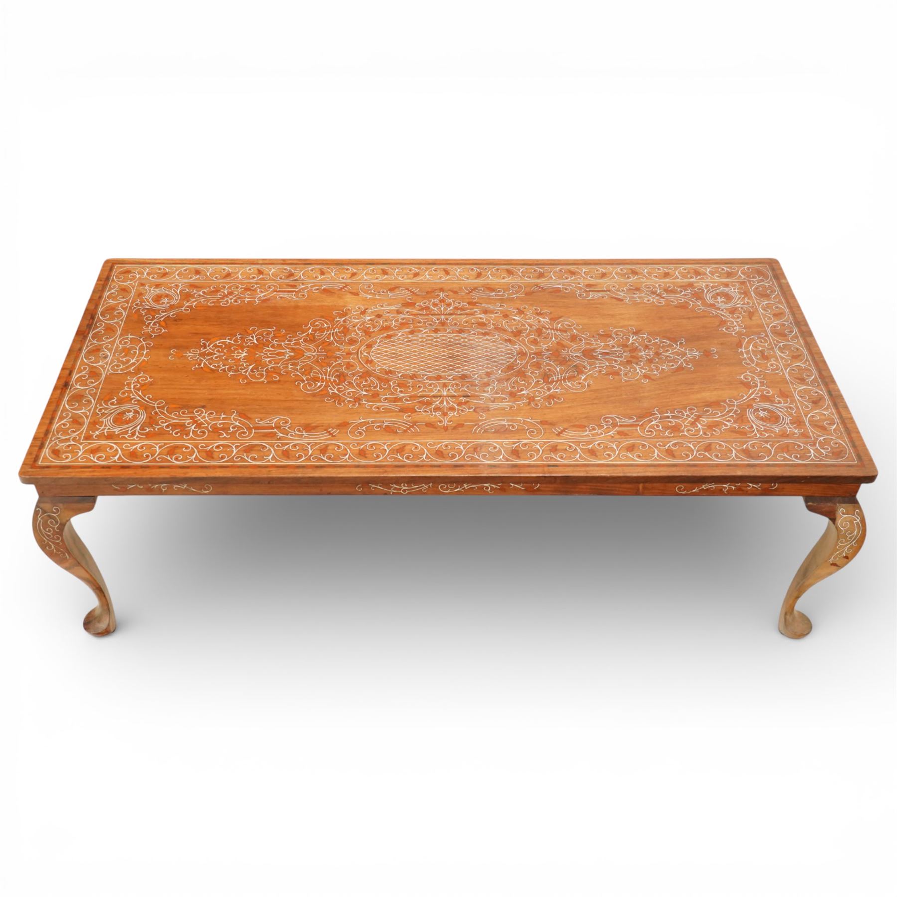 20th century Indian style bone inlaid coffee table, rectangular top profusely inlaid with scrolling foliate decoration centred by an oval medallion, matching inlay to the frieze and cabriole legs, raised on shaped feet