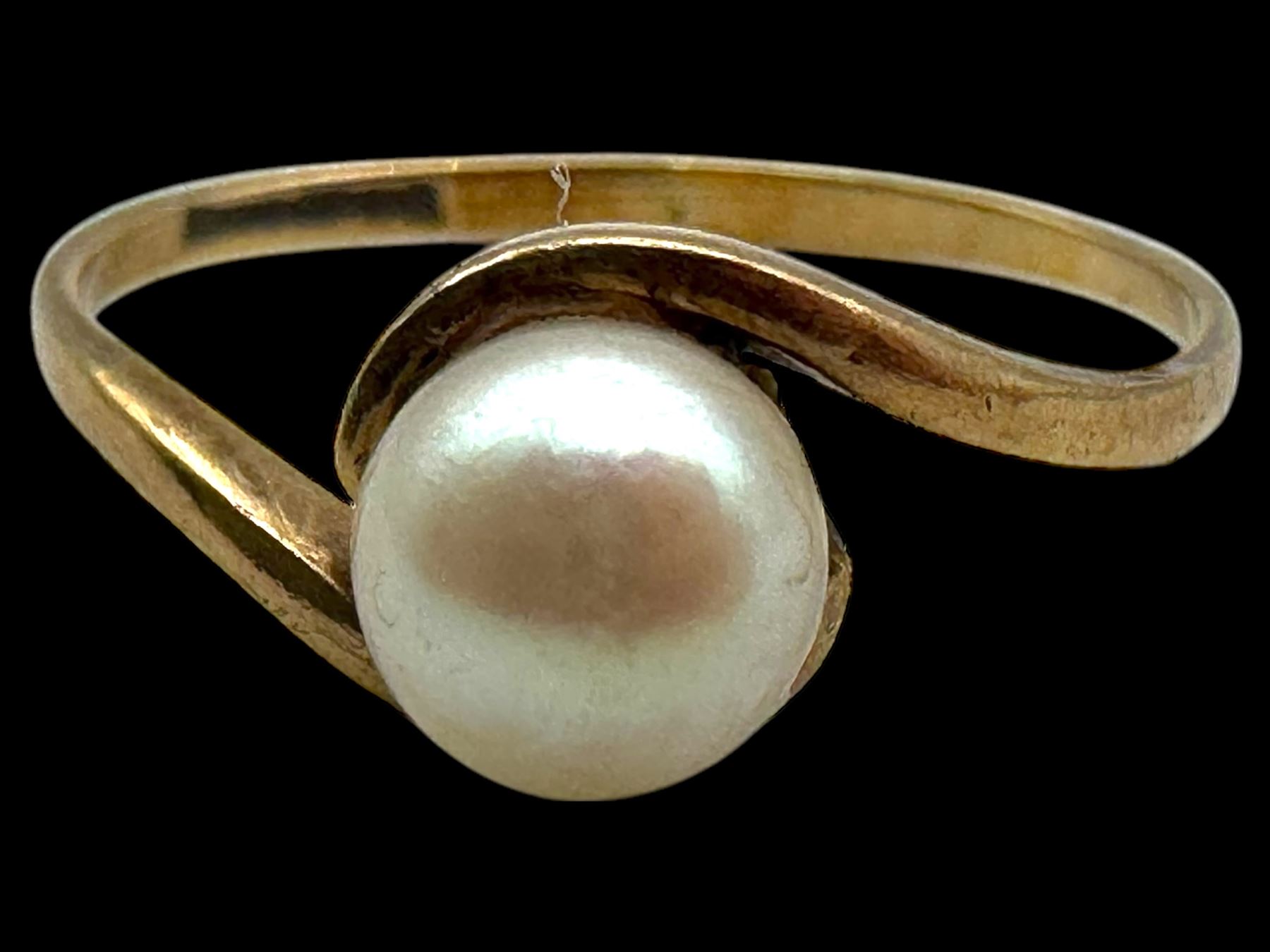 Four 9ct gold stone set rings, including garnet and pearl examples, all stamped or hallmarked