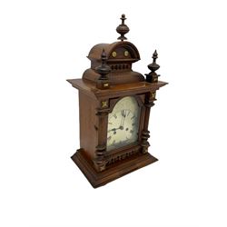A late 19th century twin train striking mantle clock manufactured in Germany by Phillip Hass & Sohn c1890, in an oak case with an arched pediment and three turned finials, with a break arch door and etched silvered dial, Roman numerals and minute track, with steel spade hands, eight-day countwheel striking movement striking the hours and half-hours on a coiled gong. With pendulum.

	




