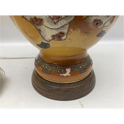 20th century Japanese vase converted to a lamp, the baluster form body decorated with samurai warriors and blossoming branches with twin handles, with wood base and fixtures, with tasselled fabric shade, H56cm excl shade