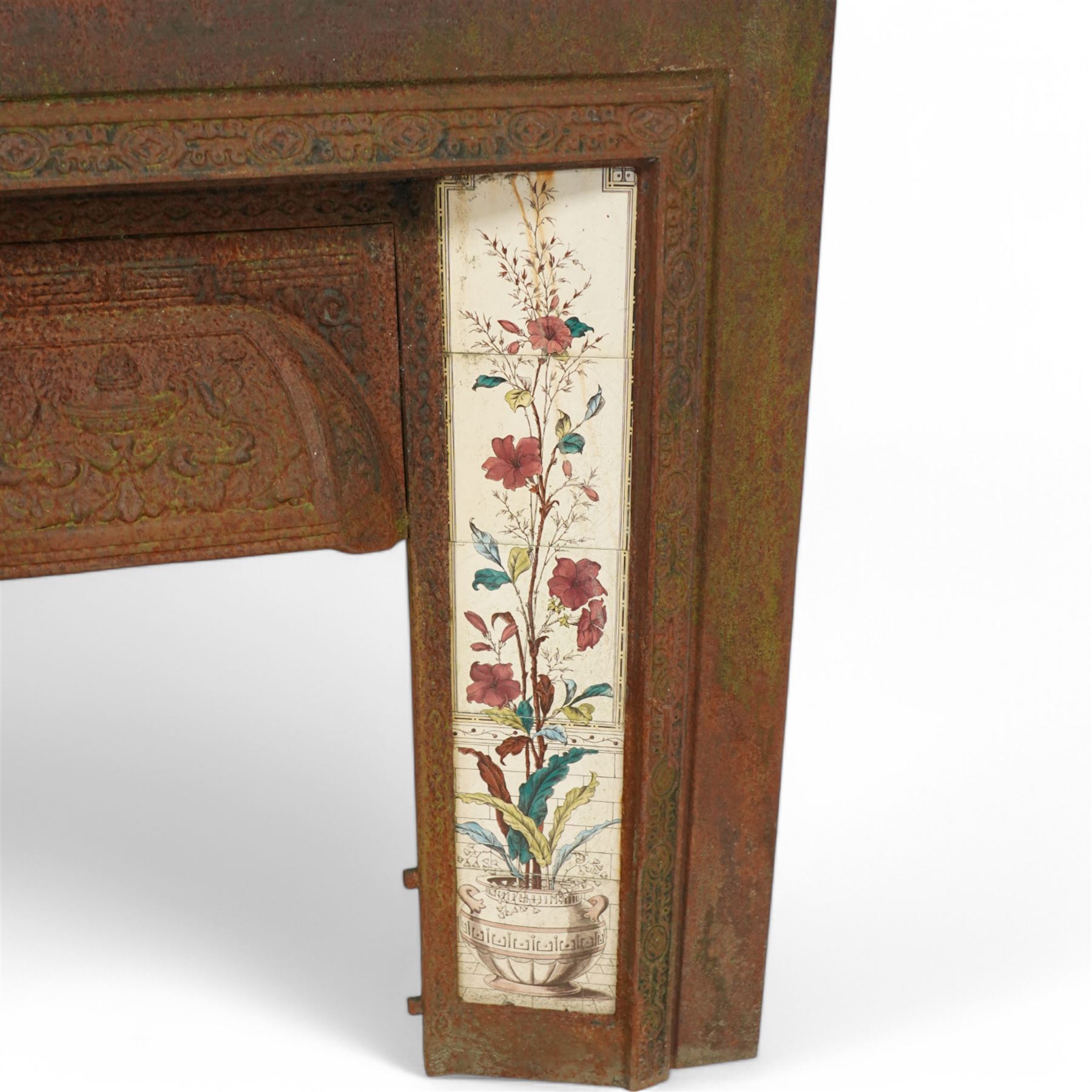 Late 19th century cast iron fire inset, with tiles decorated with flowers 