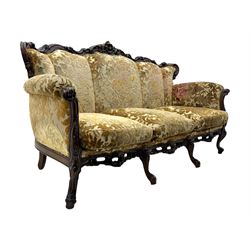 Victorian design stained wood three seater settee, top rail carved and scrolled, padded back and arms, scrolled cabriole feet 