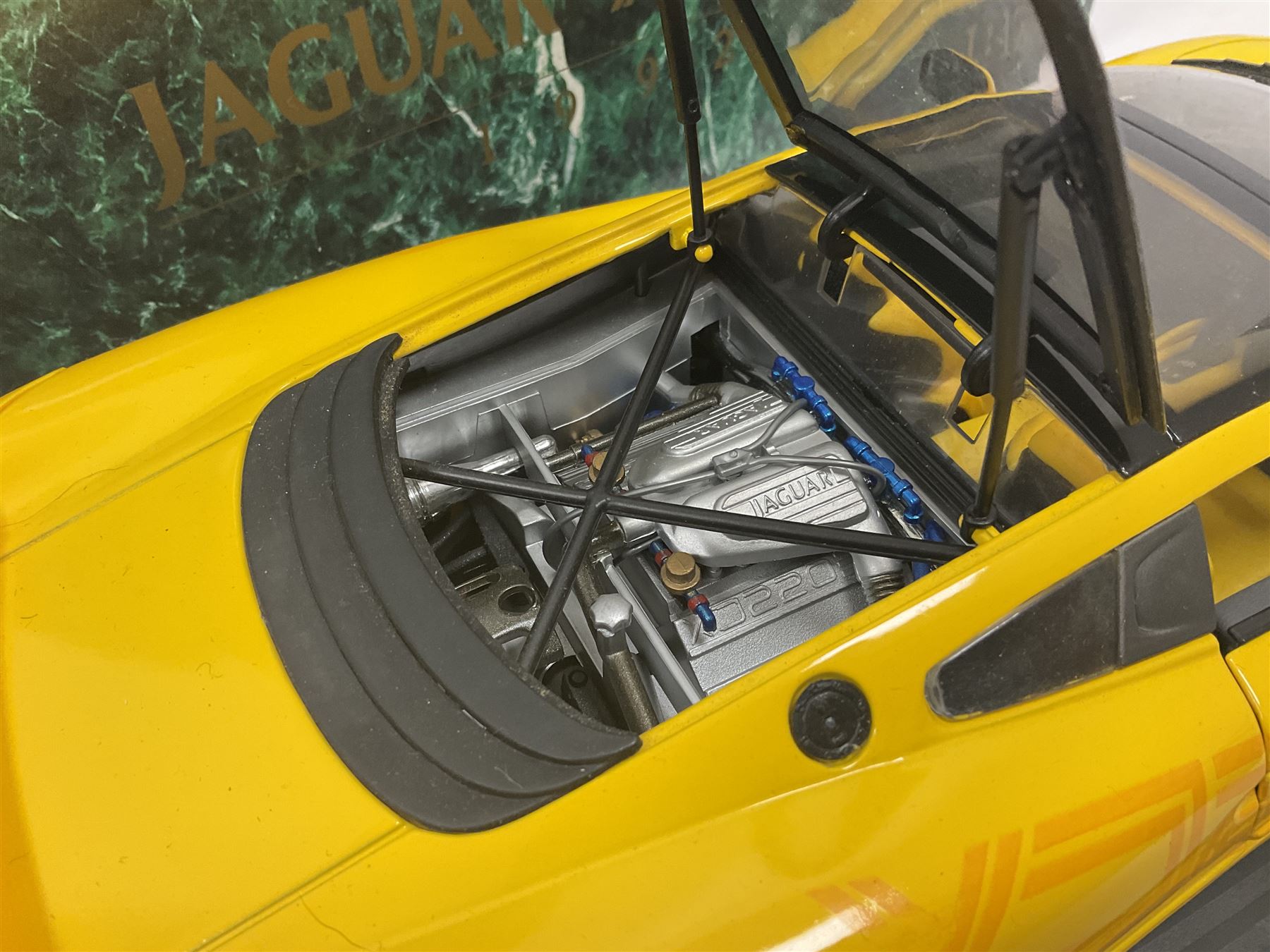 Two Maisto 1:12 scale Jaguar XJ220 ‘Racing’ cars in yellow, both on plinths in original boxes 