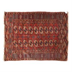 Central Asian Turkmen Tekke hand-knotted rug, madder red field decorated with rows of octa...
