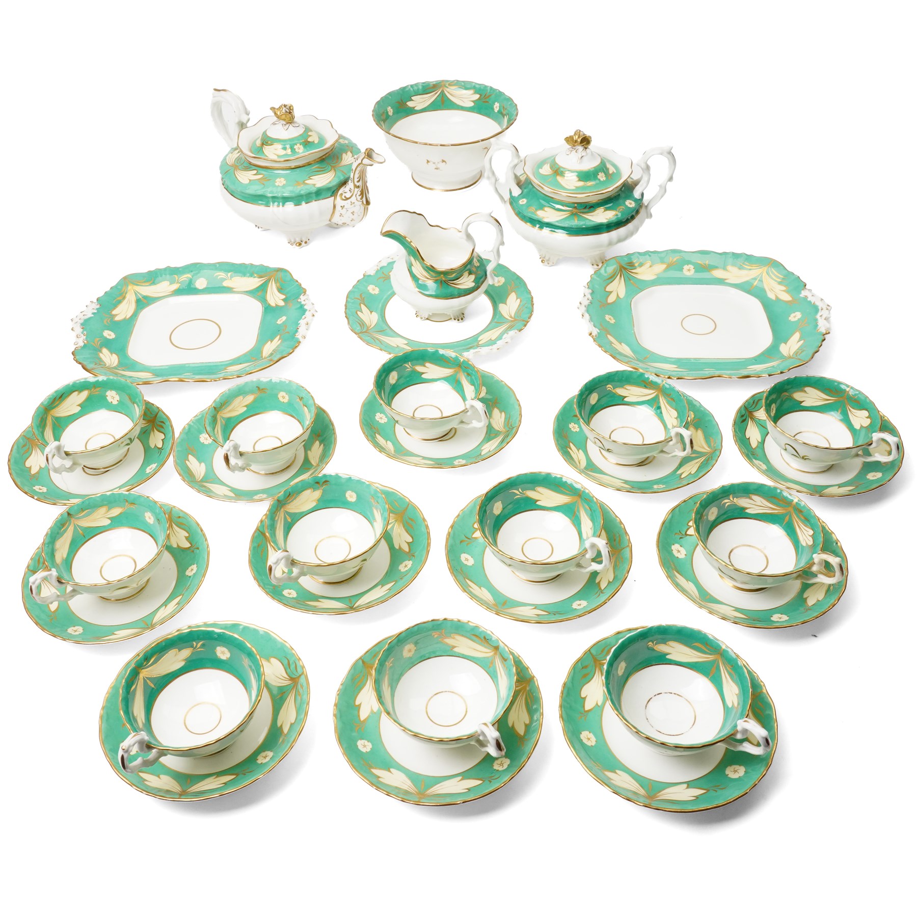 19th century porcelain tea service decorated with a border pattern of yellow leaves on a green ground comprising twelve cups and saucers, tea pot, sucrier and cover, milk jug, slop bowl and three plates, pattern number 5850