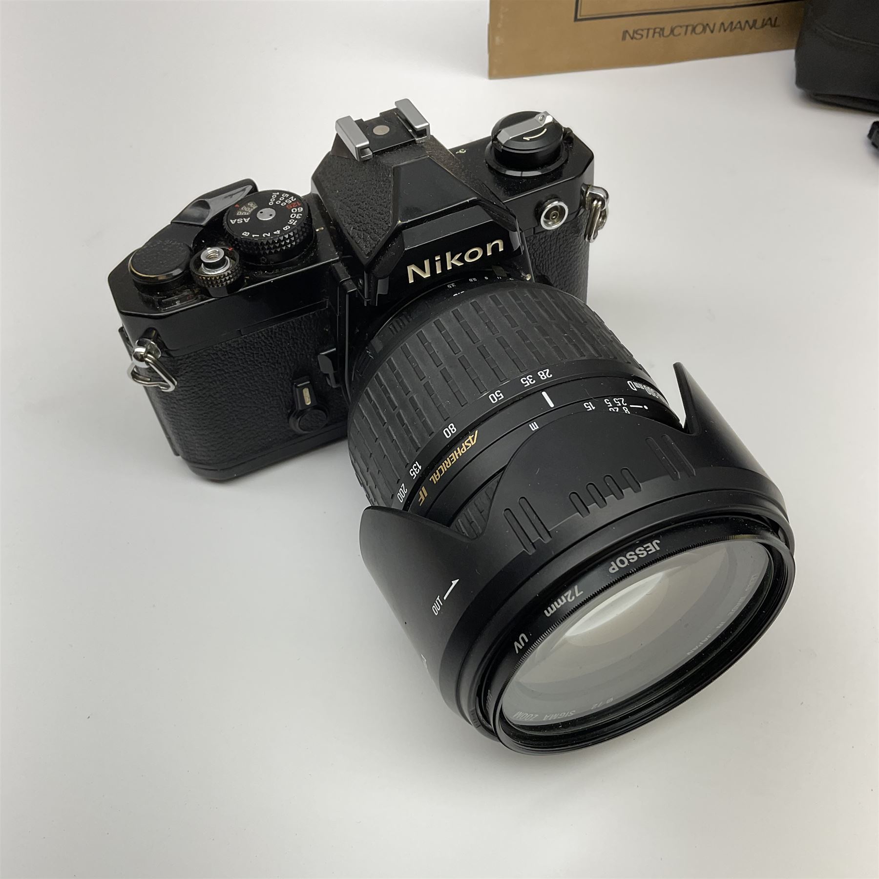 Nikon FM 35mm SLR camera body, Sigma 28-300mm 1:3.5-6.3 lens, Cosina 100mm 1:3.5 macro lens, two macro adaptors, instruction manual, Nikon 'Lite-Touch zoom' 35mm camera, and three relating carrying cases