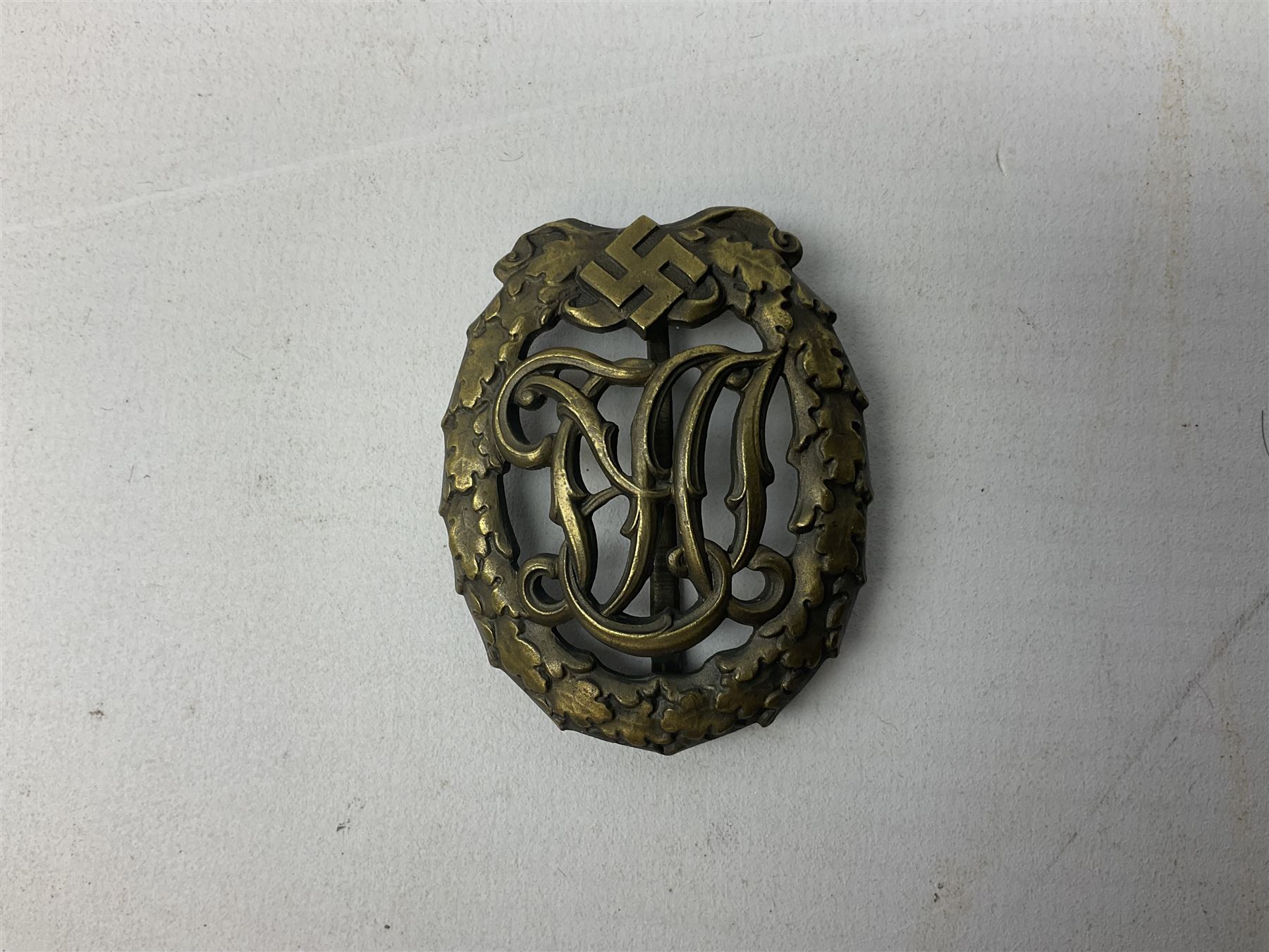 Two WW2 German Sports badges - SA sports badge marked verso 'W.Redo Eigentum D. Obersten SA. Fuhrung Saar Lautern'; and DRL sports badge marked verso 'Wernstein Jena D.R.G.M. 35269' (2)