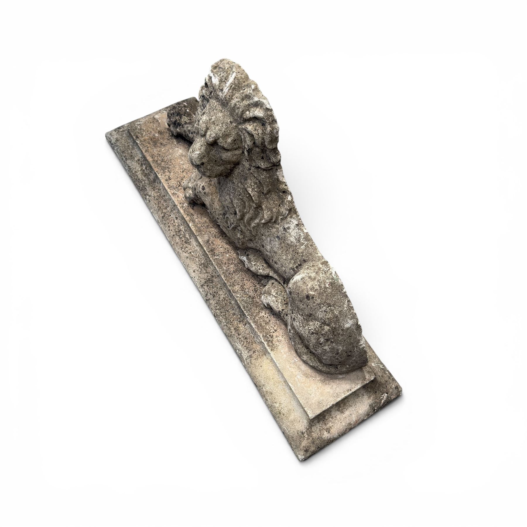 Neoclassical design cast stone garden lion, modelled recumbent with raised and flowing mane, on rectangular plinth base, with flat plain reverse, in weathered finish
