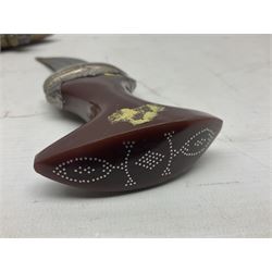 Omani Khanjar dagger, the 12.5cm curved blade with pronounced medial rib to either side, waisted horn style hilt with dome shaped pommel and inlaid pique work; in an intricately filigree decorated white metal scabbard with rings woven into the belt mount L25cm overall