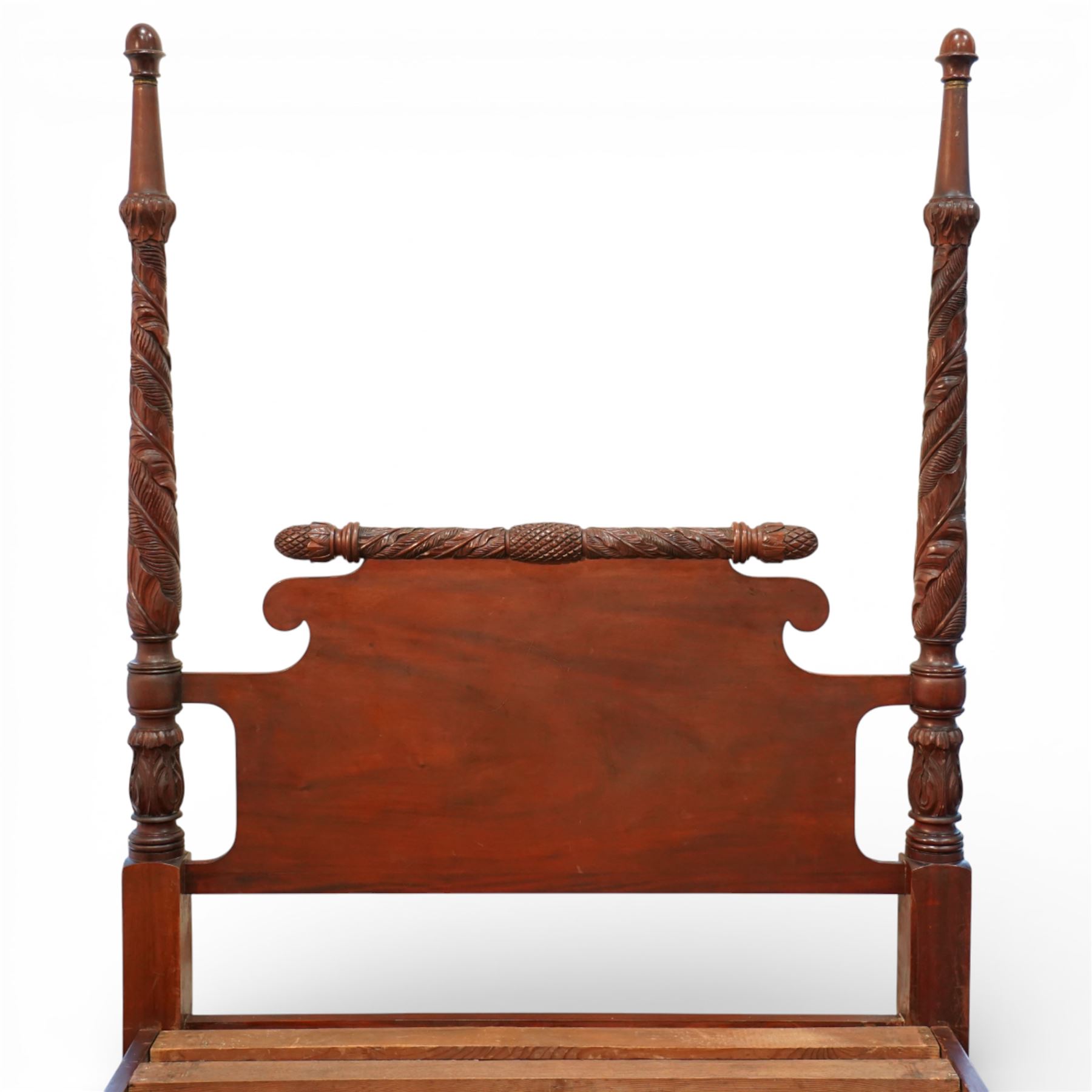 Early 19th century Regency carved mahogany four poster double bed, 4'6, the shaped headboard and footboard each surmounted by a finely carved pinecone and foliate moulded rail, flanked by ring turned and boldly spiral carved tapering posts with acorn finials, raised on square section legs, with slatted base
