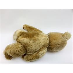 Chiltern Hugmee large teddy bear c1950s with kapok filled long-plush body, jointed swivel head with original orange and black glass eyes and vertically stitched nose and mouth, jointed limbs with card lined feet and velvet covered pads and inoperative squeaker H22