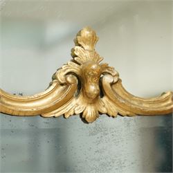 George III Chippendale design carved giltwood and gesso wall mirror, the impressive protruding pierced pediment decorated with flared acanthus leaves interspersed with flower heads and berries, over an arched outer-frame - the cresting comprised of C-scrolls carved with dripping icicle motifs, the uprights formed of scrolling acanthus with swags of grapevines and foliage, over a scrolled cartouche terminal, the inner-frame of architectural form with bell-flower details and a shaped cresting with scrolling acanthus leaves, all enclosing a central slightly bevelled rectangular mercury glass plate, surrounded by smaller plates