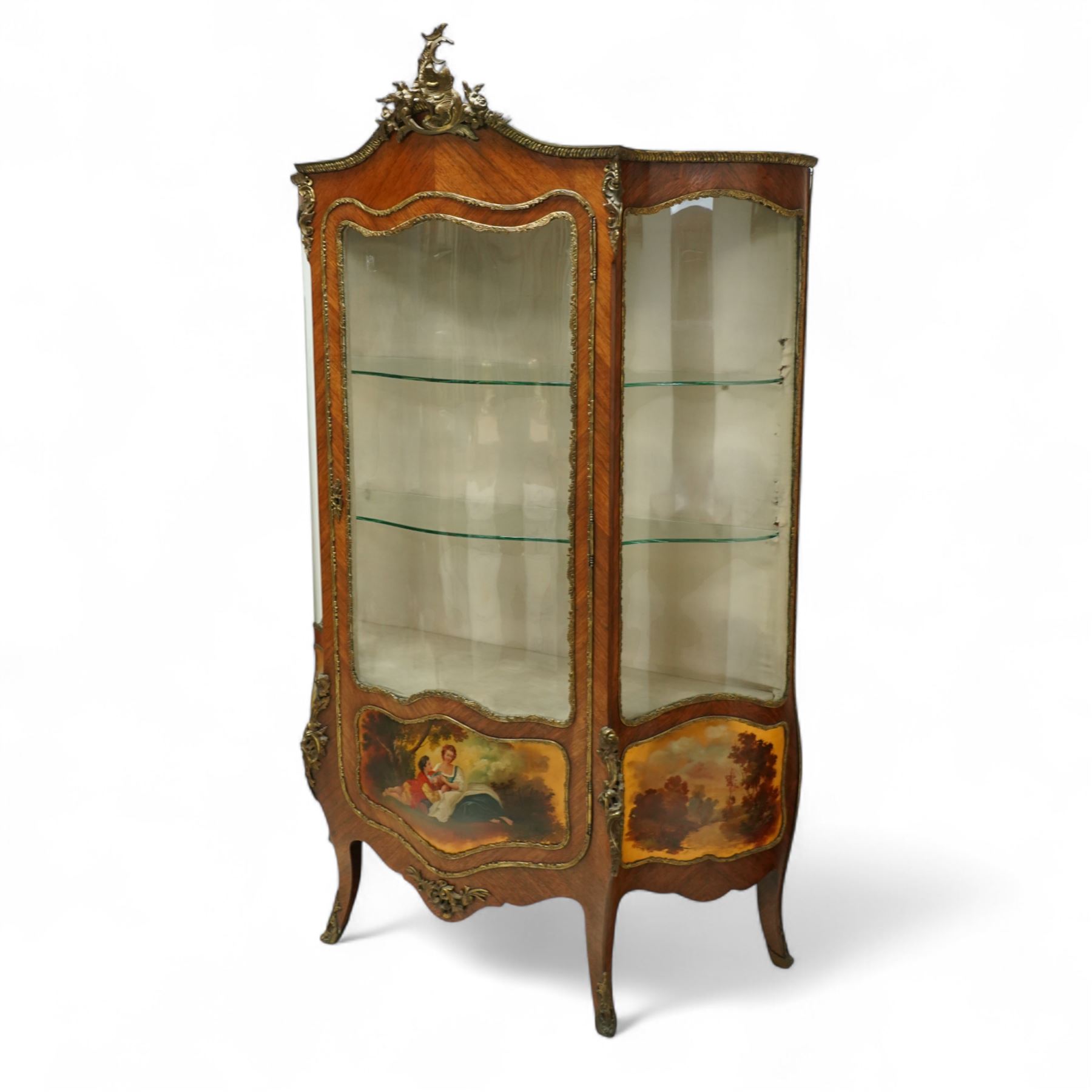 Louis XV revival kingwood Vernis-Martin serpentine fronted vitrine cabinet, arched top with gilt brass foliate mounts, glazed door with two shelves above three painted panels, depicting pastoral scenes, supported on out-swept cabriole legs with gilt brass mounts and sabots.