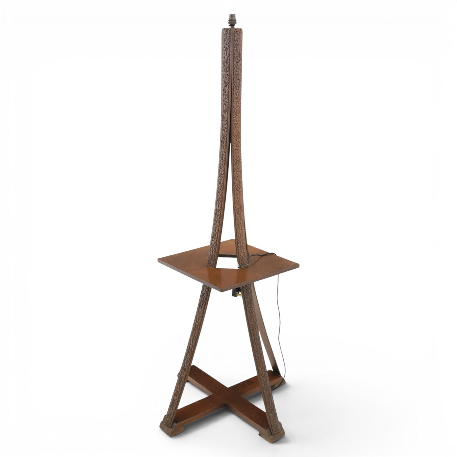 20th century stained wooden standing lamp, four foliate carved splayed supports, with square table platform, united by cruciform stretcher base, H158cm
