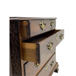 George III Chippendale design mahogany chest, moulded rectangular top with canted corners, wide canted uprights with blind fretwork decoration, two short and three long with moulded fronts, shaped brass handle plates, on ogee bracket feet 