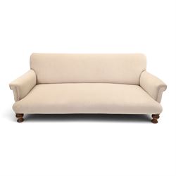Late Victorian oak framed low three-seat settee, of traditional shape with low rolled spru...