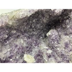 Amethyst crystal ‘cathedral’ geode, free standing with flat base and prepared outer surface, with well-defined crystals of various sizes within the cavern, H36, L35cm