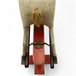20th century carved and painted rocking horse, with original dappled paint finish, studded leather saddle and reins, on later red and black swing frame