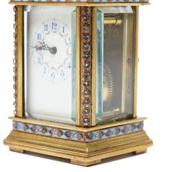 French- Edwardian miniature brass 8-day timepiece carriage clock with cloisonné panels to both base and cornice and paste gems to the front columns, decorative porcelain dial with a floral swag, blue Arabic numerals, minute track and pieced steel hands, square viewing glass to the top with a silvered lever escapement, with original leather bound traveling case.