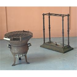 Victorian cast iron stick stand, three divisions raised on reeded columns, over a rectangular base with drip tray (H59cm, W50cm, D26cm) together with a cast iron patio stove on tripod supports. (H41cm) (2) - COLLECTION BY APPOINTMENT FROM: The White House, Thirsk Road, Easingwold, York, YO61 3NF - CALL 01723 507111 TO ARRANGE