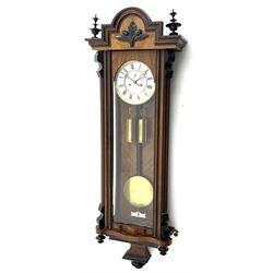 Late 19th century Vienna style wall clock in walnut and ebonised case, the stepped pediment with acorn and oak leaf carved mount, circular Roman dial with subsidiary seconds dial, twin train driven movement