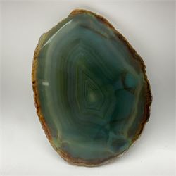 Pair of green agate slices, polished with rough edges raised upon silvered metal stands, H19cm