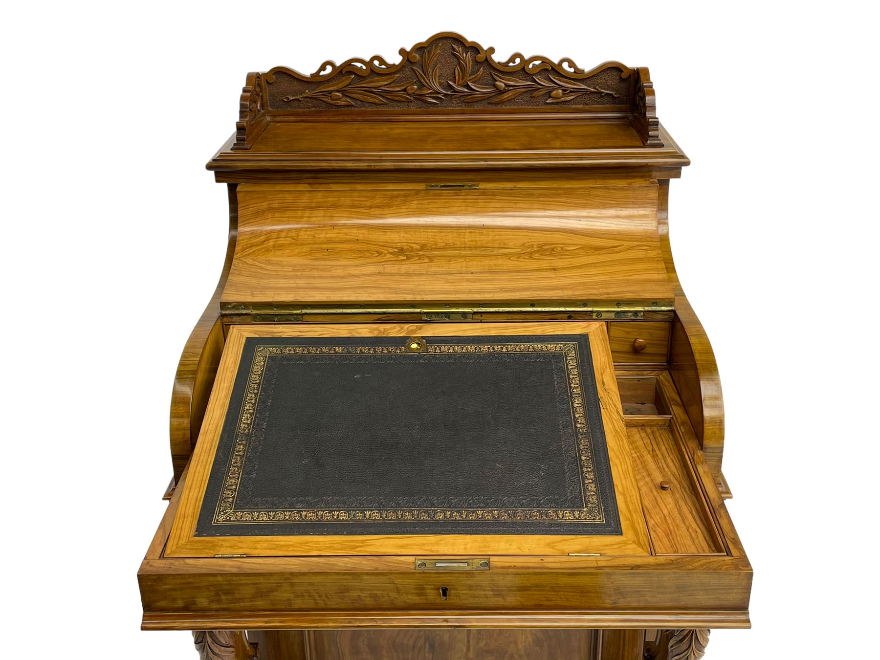 Fine and unusual 19th century olivewood piano top davenport, raised shaped back carved with olive branches and olives, the top hinges to reveal lidded and correspondence compartments, the piano lid enclosing sliding top with hinged and adjustable writing surface with leather inset, right-hand panelled door enclosing four drawers, olive branch and scroll carved cabriole front supports on moulded and shaped platform, turned cup feet with recessed castors 