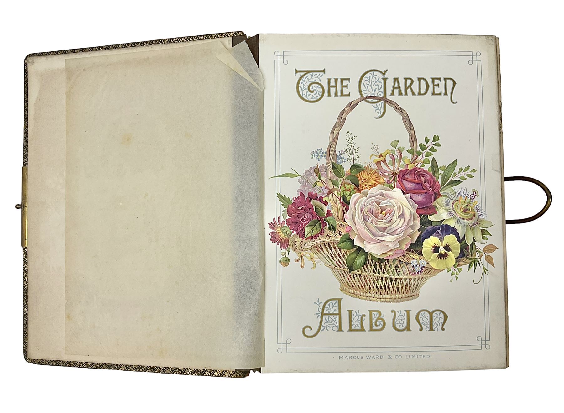  Victorian leather bound photo album, the interior leaves containing apertures of various sizes and shapes of portraits surrounded by printed floral designs, with brass clasp and painted gold decoration to edges, H30cm
