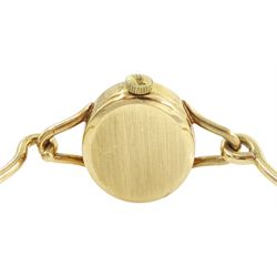 Roy King ladies 9ct gold manual wind wristwatch, black oval dial, on 9ct gold bangle, London 1978