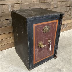 Samuel Withers & Co of West Bromwich - Victorian cast iron safe, the brass handle modelled as a clenched fist, painted in red, orange and black, with key. Ground floor delivery only, no steps.
