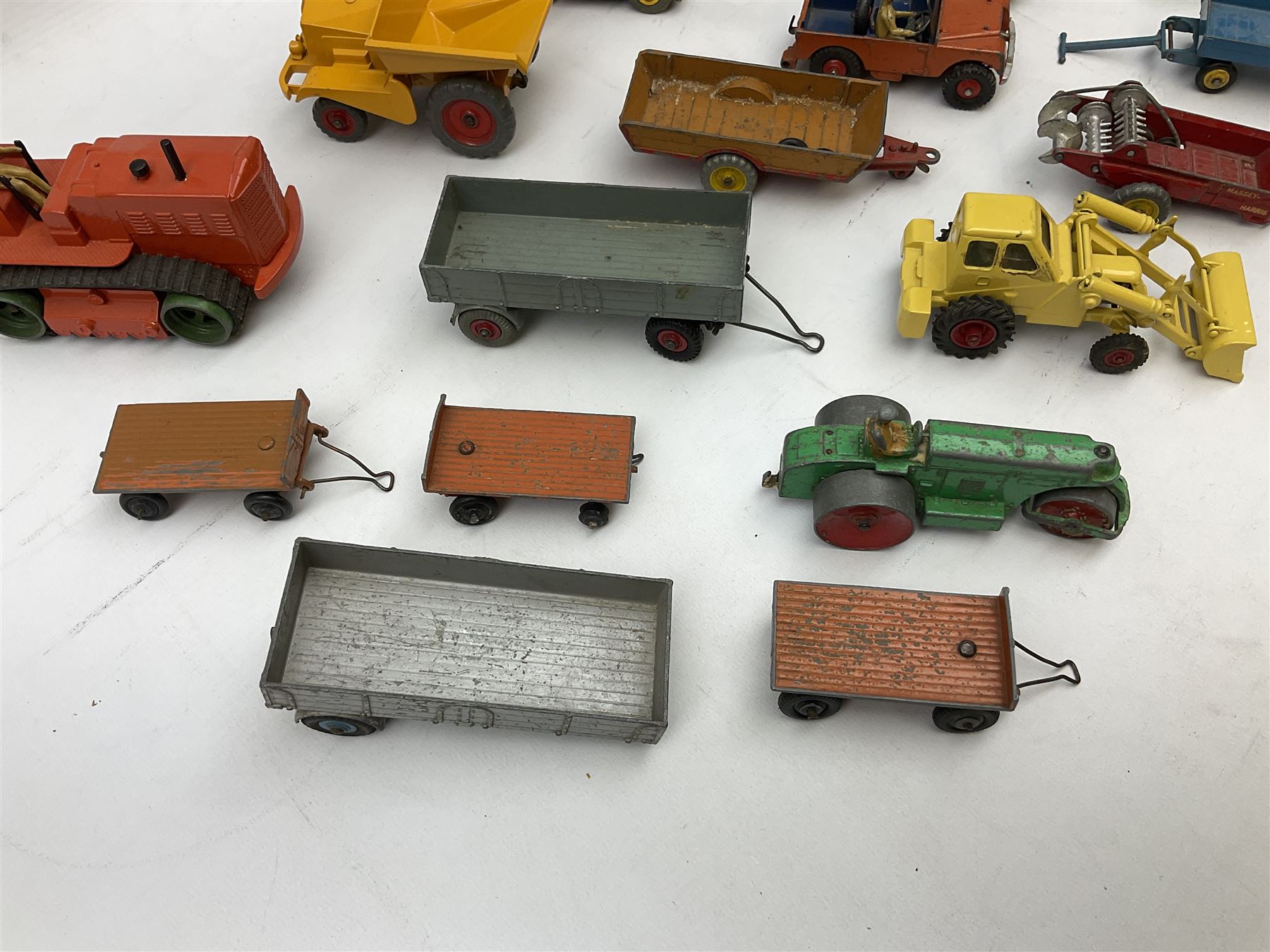 Dinky - nineteen unboxed and playworn/repainted die-cast models including Muir Hill Dumper, Muir Hill 2WL and Heavy Tractor; all repainted; Coles Mobile Crane, two Aveling-Barford steam rollers; Massey-Harris tractor and manure spreader; Land Rover; nine various trailers etc (19)