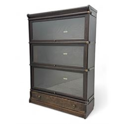 Globe Wernicke - early 20th century oak three-tier stacking library bookcase, three glazed sections enclosed by hinged and sliding doors, raised above a single lower drawer with metal drop handles