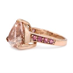 9ct rose gold morganite and tourmaline ring, single trilliant cut morganite of approx 5.35 carat, each shoulder set with four round cut tourmalines, Birmingham 2011