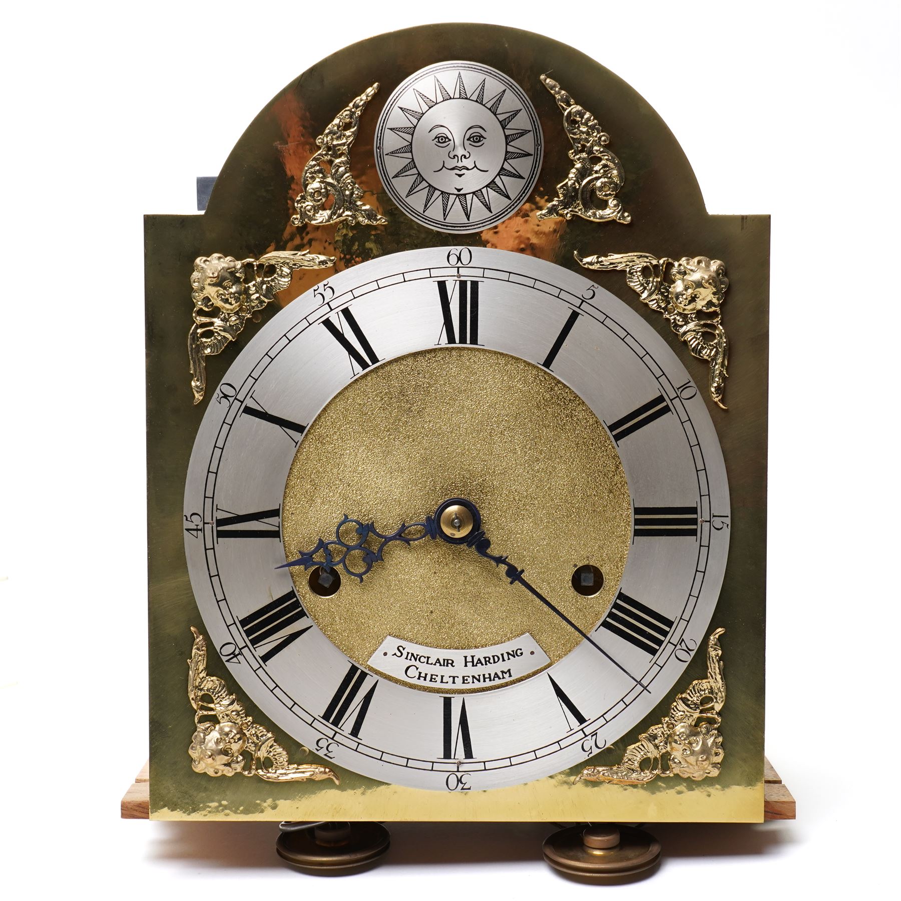 Mouseman - Oak 8-day grandmother clock, with a high quality weight driven movement and dial by Sinclair and Harding & Co of Cheltenham (No 477), brass break-arch dial with pierced steel hands, cast spandrels and a matted dial centre, silvered chapter with Roman numerals and minute track, dial pinned to  a two train rack striking movement, striking the hours on a cast bell, case with a full length glazed door and visible brass cased weights and conforming brass cased cylindrical pendulum. Signature carved mouse to the top of the arch of the case, from the workshop of Robert Thompson of Kilburn
With key.
Longcase.