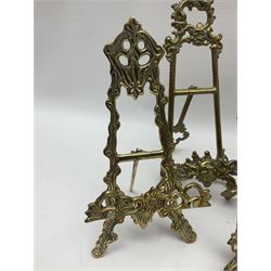 Nine ornate cast brass easel stands of various sizes, H24cm