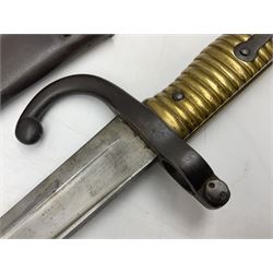 French model 1866 sabre bayonet, the 57.5cm curving blade marked St. Etienne 1868; in associated steel scabbard L71cm overall