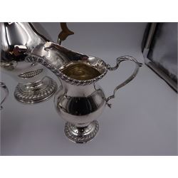 Mid 20th century three piece silver coffee service, comprising coffee pot, milk jug and twin handled open sucrier, of waisted form upon circular domed foot,  with oblique gadrooned rim, the milk jug and sucrier with acanthus capped handles, the coffee pot with wooden handle and finial, hallmarked William Comyns & Sons Ltd , London 1961, coffee pot H27.5cm